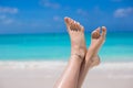 Close up of female feet on white sandy beach Royalty Free Stock Photo