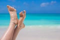 Close up of female feet on white sandy beach Royalty Free Stock Photo