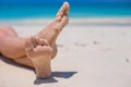 Close up of female feet on white sandy beach Royalty Free Stock Photo