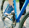 Close up female foot on pedal of bicycle