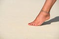 Close-up of female foot in the sand on the tropical beach. Vacation holidays Royalty Free Stock Photo