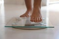 Close-up of female foot stepping on weight scale. Healthy lifestyle, diet and sport concept Royalty Free Stock Photo