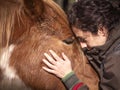 Close up of female forming bond with a piebald pony