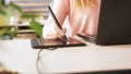 Close-up of female graphic designer`s hand using interactive pen display, digital drawing tablet and pen on a computer Royalty Free Stock Photo