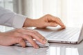 Close-up female hand of business woman using mouse to working with laptop computer Royalty Free Stock Photo