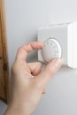 Close Up Of Female Hand On Central Heating Thermostat Royalty Free Stock Photo