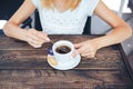 Close up of a female hand with a cup of espresso and a spoon Royalty Free Stock Photo