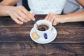 Close up of a female hand with a cup of espresso and a spoon Royalty Free Stock Photo