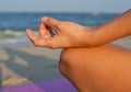 Close-up female hand in gyan mudra and lotus position. Woman practicing yoga and meditating Royalty Free Stock Photo