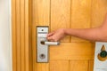 Close up of female hand hold key card and open electronic lock door Royalty Free Stock Photo