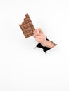 Female hand holding a bitten bar of chocolate