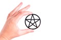 Hand holding a black pentagram on white Royalty Free Stock Photo