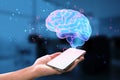 Close up of female hand holding cellphone with glowing human brain hologram on blurry background. Artificial intelligence, Royalty Free Stock Photo