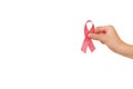 Close up of female hand holding pink ribbons,  over white studio background wall with copy space. Breast cancer awareness Royalty Free Stock Photo