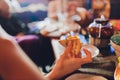 Close up female hand holding, taking slice, piece of pizza from box, friends sitting together in cafe, spending free Royalty Free Stock Photo