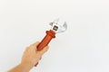 Close-up of female hand holding wrench on white background. Royalty Free Stock Photo