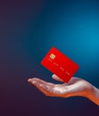 Close up female hand holds levitating template mockup Bank credit card with online service isolated on blue background