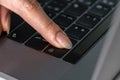 Close-up female hand pressing a Backspace key for delete on laptop keyboard Royalty Free Stock Photo