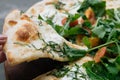 Close up Female hand take a piece of Fresh italian pizza with tomatoes, cheese, basil on black stone table. Copy space Royalty Free Stock Photo