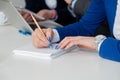 Close up of female hand taking notes on a business meeting Royalty Free Stock Photo