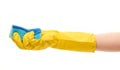 Close up of female hand in yellow protective rubber glove holding blue cleaning sponge Royalty Free Stock Photo