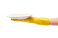 Close up of female hand in yellow protective rubber glove holding clean white plate Royalty Free Stock Photo