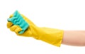 Close up of female hand in yellow protective rubber glove holding green cleaning sponge Royalty Free Stock Photo