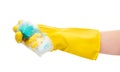 Close up of female hand in yellow protective rubber glove squeezing green cleaning sponge in foam Royalty Free Stock Photo