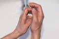 close up of female hands being washed in a white sink with soap Royalty Free Stock Photo