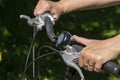 Female hands on a bicycle handlebar while ringing