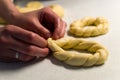 Close up of female hands braiding dough Royalty Free Stock Photo