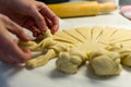 Close up of female hands braiding, preparing dough for baking Royalty Free Stock Photo