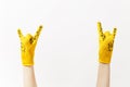 Close up of female hands in building yellow gloves horns gesture, depicting heavy metal rock and roll sign isolated on Royalty Free Stock Photo