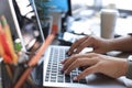 Close up of female hands busy typing on laptop in modern office