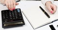 Close-up of female hands with calculator, fountain pen and notebook Royalty Free Stock Photo