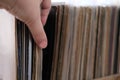 Close-up of female hands, choosing vinyl records, antiques, old furniture, tables, used things, clothes and other goods are sold Royalty Free Stock Photo