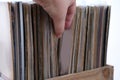 close-up of female hands, choosing vinyl records, antiques, old furniture, tables, used things, clothes and other goods are sold Royalty Free Stock Photo