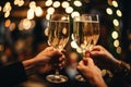 Close-up of female hands clinking glasses of champagne in restaurant, Close up of people toasting with christmas champagne glasses