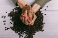 Close-up of female hands coated with scrub and coffee beans