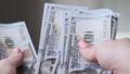 Close up of female hands counting a amount of money by hand.