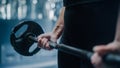 Close Up on Female Hands Covered in Chalk, Lifting a Barbell. Professional Resolute Future Female Royalty Free Stock Photo