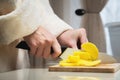 Close-up of female hands cutting fresh peeled potatoes tomatoes on cutting board at home kitchen Royalty Free Stock Photo