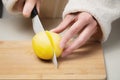 Close-up of female hands cutting fresh peeled potatoes tomatoes on cutting board at home kitchen Royalty Free Stock Photo