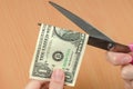 Female hands cutting one dollar bill with scissors Royalty Free Stock Photo