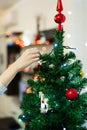 Close-up of female hands decorating the top of a Christmas tree. Royalty Free Stock Photo