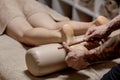 Close-up of female hands doing foot massage. Woman enjoyingreflexology foot massage in wellness spa Royalty Free Stock Photo