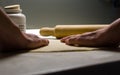 Close up of female hands, dough and rolling pin on kitchen working table