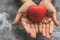 Close up female hands giving red heart as heart donor. Valentine day of love concept. Medical ventilator and heart donator charity