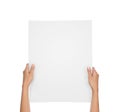 Hands holding blank paper sheet isolated on white