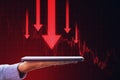 Close up of female hands holding cellphone with downward red business chart and arrows on blurry background. Crisis, recession and